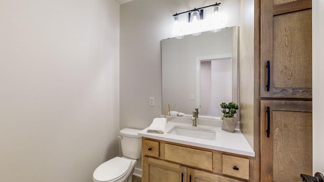 bathroom featuring toilet and vanity