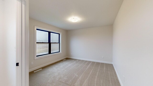 1701 20th Ave Circle NE, Kasson, MN 55944 - empty room featuring baseboards and light colored carpet