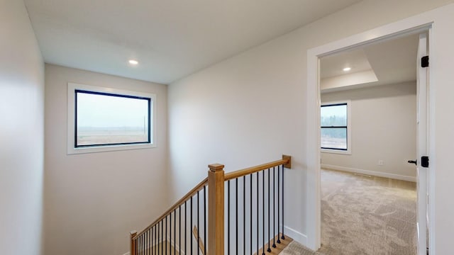 hallway featuring light colored carpet