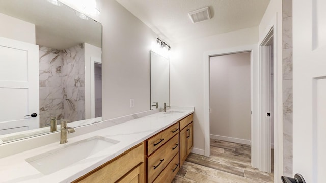 bathroom featuring hardwood / wood-style flooring and vanity