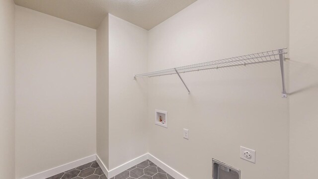 1701 20th Ave Circle NE, Kasson, MN 55944 - laundry room featuring hookup for an electric dryer, hookup for a washing machine, baseboards, and dark tile patterned flooring