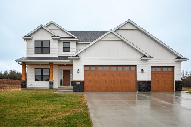 1701 20th Ave Circle NE, Kasson, MN 55944 - view of front facade with board and batten siding, stone siding, roof with shingles, an attached garage, and driveway