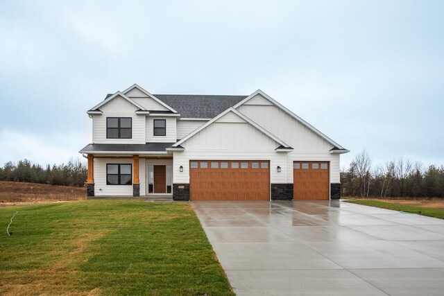 1701 20th Ave Circle NE, Kasson, MN 55944 - modern farmhouse featuring concrete driveway, stone siding, a front yard, roof with shingles, and a garage
