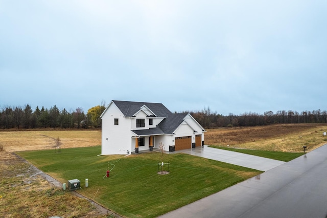 view of front of house featuring a garage and a front yard