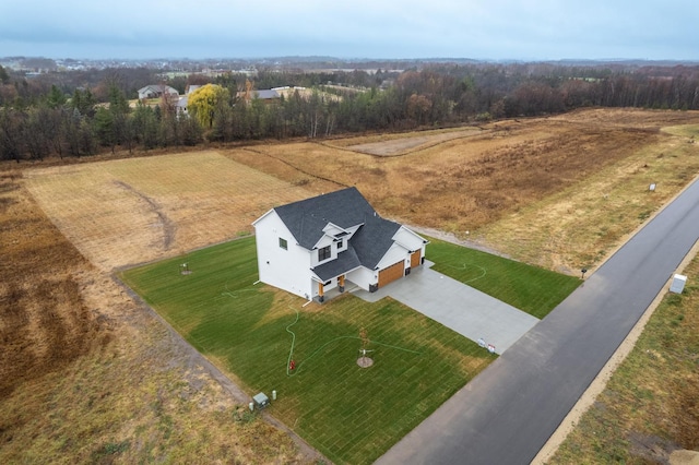 birds eye view of property with a rural view