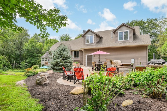 back of house with a patio area and a lawn