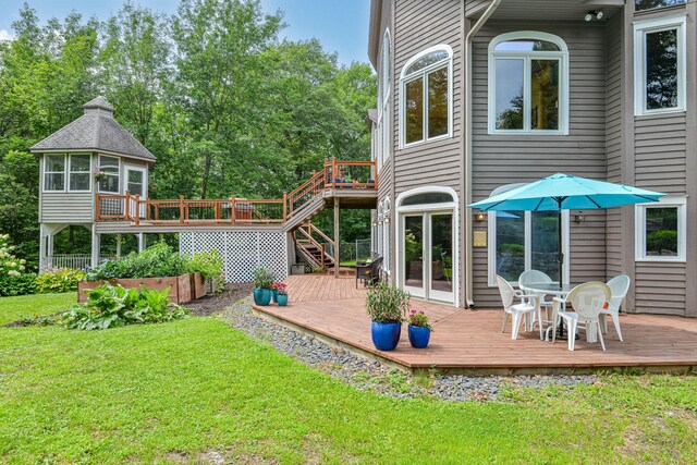 back of house with a yard and a deck