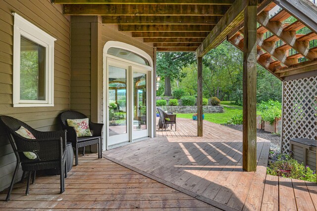 wooden deck featuring french doors and a pergola