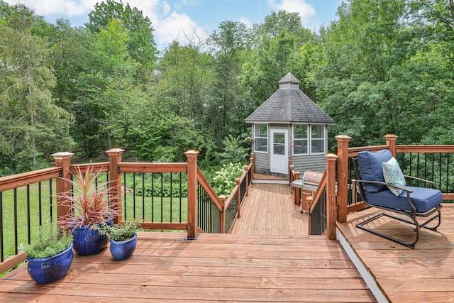 wooden terrace with a lawn