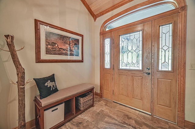 foyer featuring crown molding and lofted ceiling