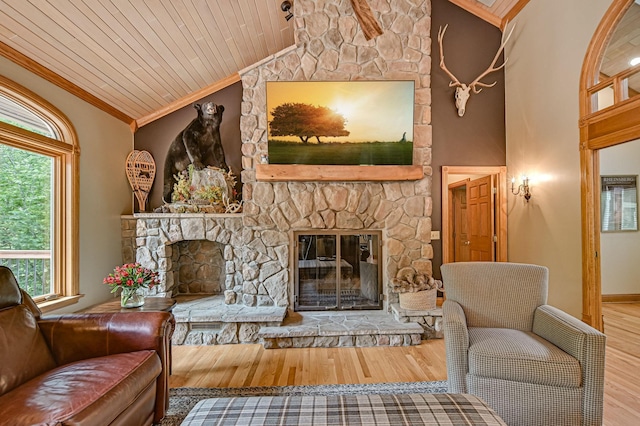 living room with a fireplace, wood ceiling, ornamental molding, wood-type flooring, and vaulted ceiling