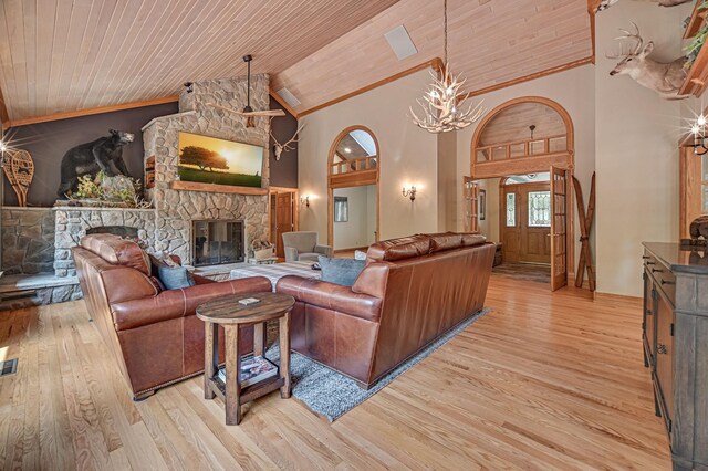 living room featuring a fireplace, light wood-type flooring, wood ceiling, a chandelier, and high vaulted ceiling