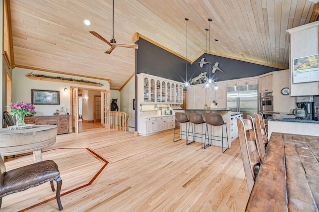 dining room with wooden ceiling, crown molding, high vaulted ceiling, ceiling fan, and light wood-type flooring