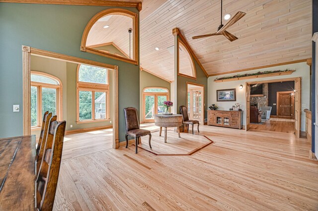 interior space with wood ceiling, light hardwood / wood-style flooring, ceiling fan, and high vaulted ceiling