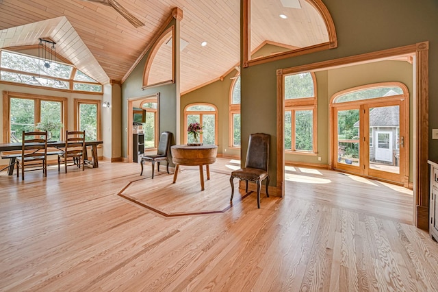 interior space featuring light wood-type flooring, high vaulted ceiling, a wealth of natural light, and wooden ceiling