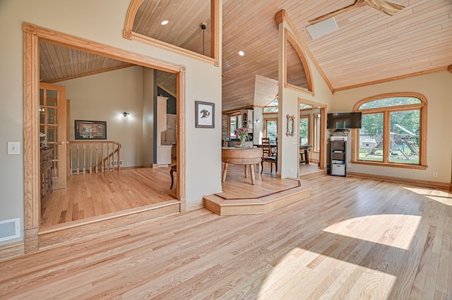 unfurnished living room with light wood-type flooring, wood ceiling, high vaulted ceiling, and ceiling fan