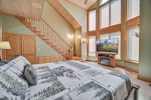 bedroom featuring high vaulted ceiling, wood ceiling, and light carpet