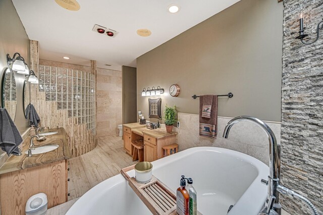 bathroom featuring vanity, hardwood / wood-style floors, and independent shower and bath