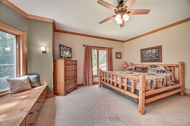 bedroom featuring crown molding, ceiling fan, and carpet flooring