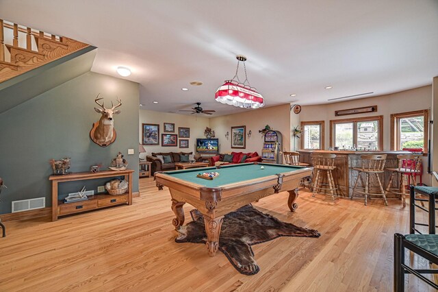 playroom with light hardwood / wood-style flooring, ceiling fan, bar, and pool table