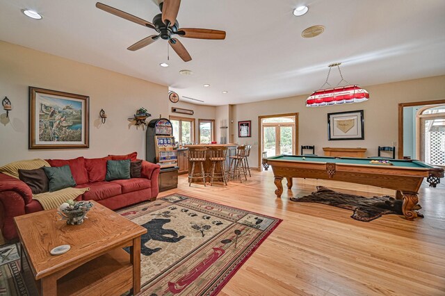 playroom featuring billiards, ceiling fan, indoor bar, and light hardwood / wood-style flooring