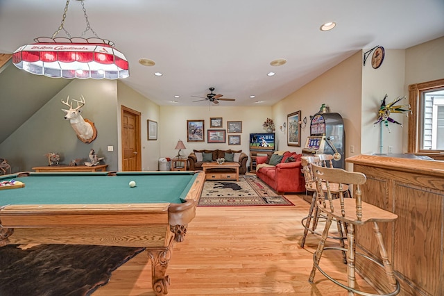 recreation room featuring bar area, hardwood / wood-style floors, ceiling fan, and pool table