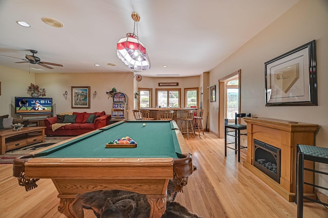 game room with bar area, billiards, light hardwood / wood-style floors, and ceiling fan