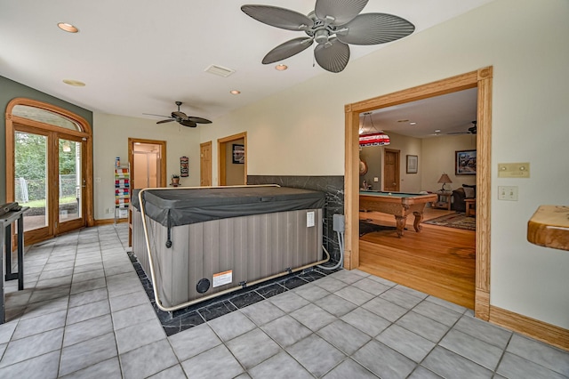 kitchen with french doors, light hardwood / wood-style flooring, ceiling fan, and pool table