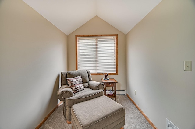 sitting room with lofted ceiling, baseboard heating, and light carpet