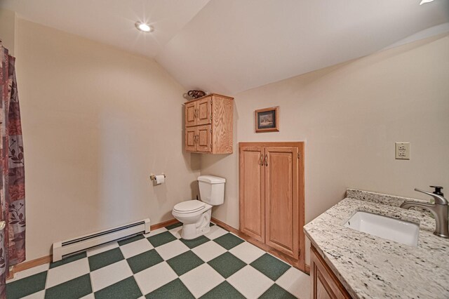 bathroom featuring lofted ceiling, vanity, baseboard heating, and toilet