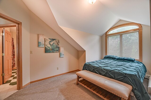 carpeted bedroom featuring vaulted ceiling