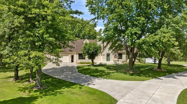 view of front of home featuring a garage and a front lawn