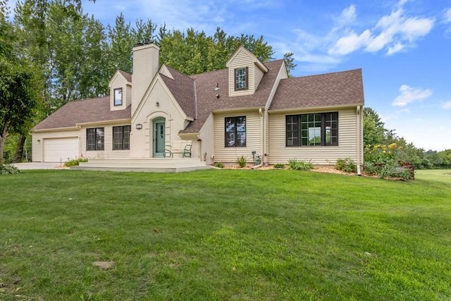 view of front of property with a garage and a front lawn