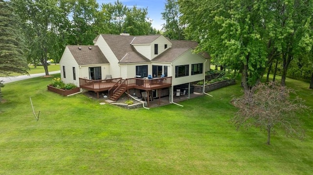 back of house with a deck and a lawn