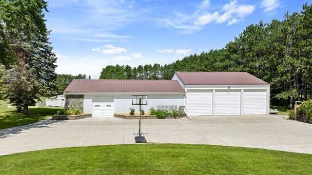 view of front of home with a garage and a front lawn