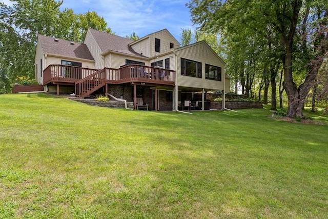 rear view of house featuring a yard and a deck