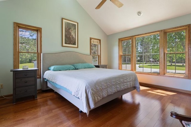 bedroom featuring dark wood-type flooring, ceiling fan, and high vaulted ceiling