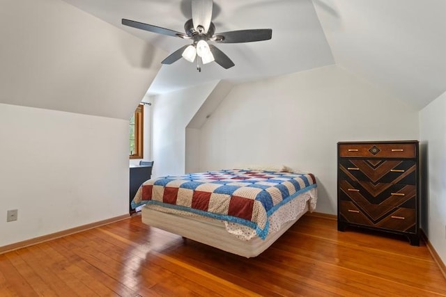 bedroom with lofted ceiling, hardwood / wood-style flooring, and ceiling fan