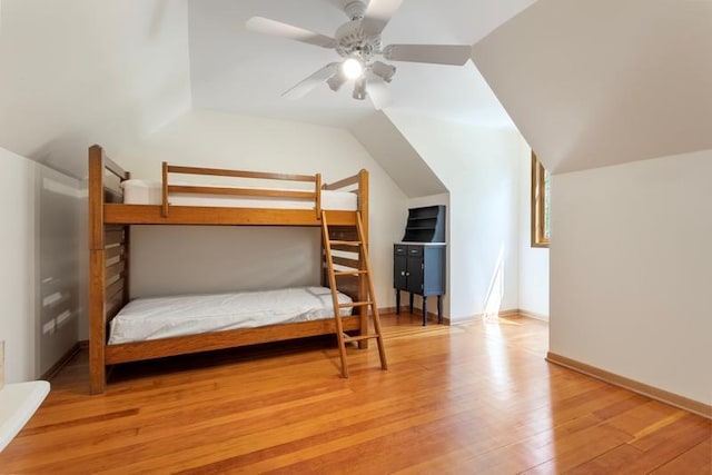 bedroom with lofted ceiling, light hardwood / wood-style flooring, and ceiling fan