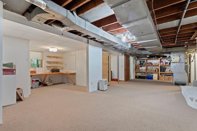 basement featuring carpet flooring and heating unit