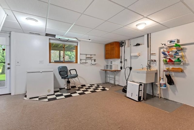 interior space with sink and a paneled ceiling