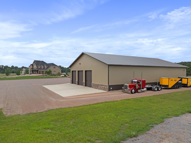 view of outdoor structure featuring a yard and a garage