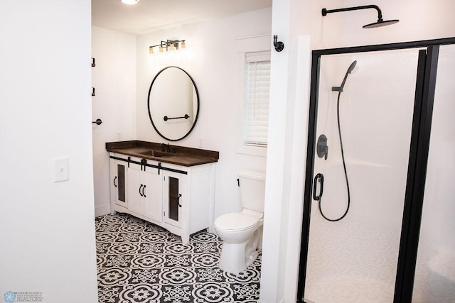 bathroom with tile patterned flooring, toilet, a shower stall, and vanity