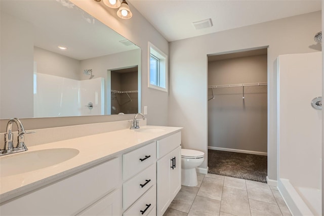 bathroom featuring tile patterned floors, walk in shower, vanity, and toilet