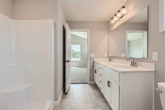 bathroom with tile patterned flooring, vanity, and toilet