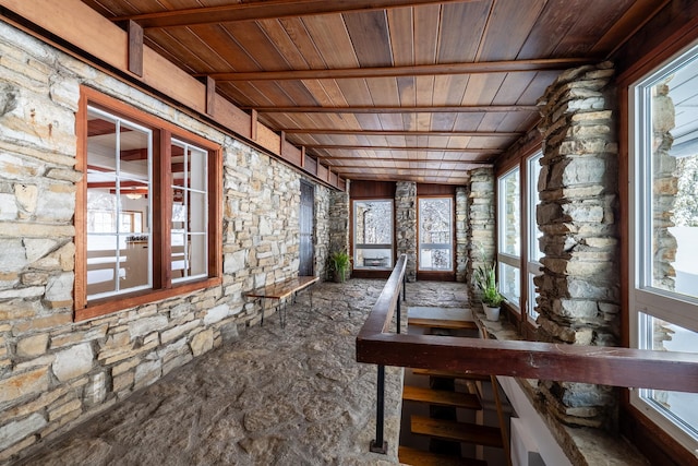 unfurnished sunroom with wood ceiling