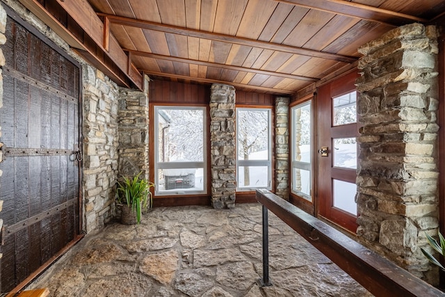 unfurnished sunroom with wooden ceiling and vaulted ceiling with beams