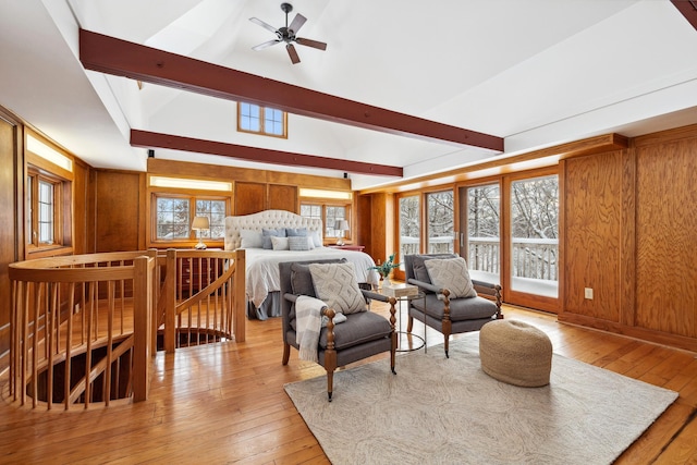 bedroom featuring wooden walls, vaulted ceiling with beams, and hardwood / wood-style flooring