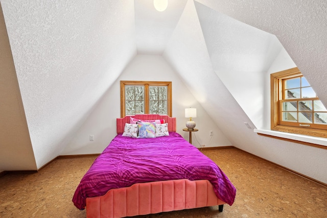 bedroom featuring lofted ceiling, carpet flooring, baseboards, and a textured ceiling