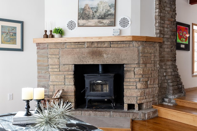 room details featuring a wood stove and wood finished floors